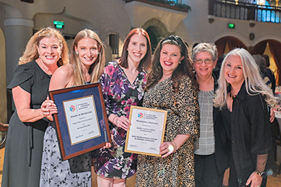 Theta Foundation staff members with two FFE awards received at its annual conference.